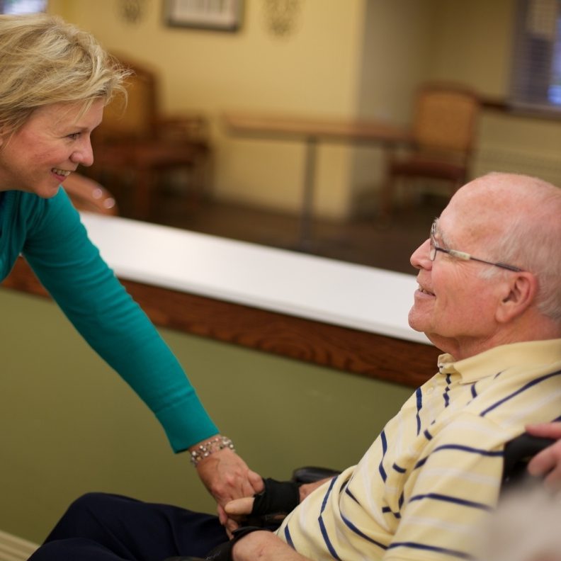 Someren Glen Senior Living Community in Centennial, CO - team member chatting with resident square